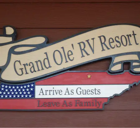 Grand Ole' RV Resort sign with welcoming slogan.