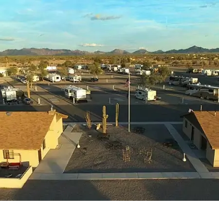 RV park with cacti at sunset in desert.