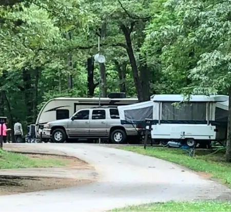 Campground scene with trucks and travel trailers.