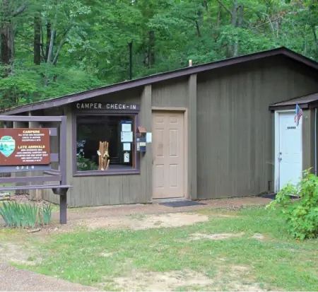 Campground check-in cabin surrounded by trees