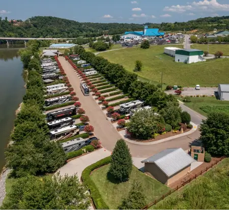 Aerial view of outdoor recreational vehicle dealership near river.