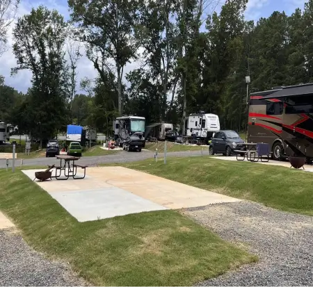 RV park with camping trailers and picnic table.