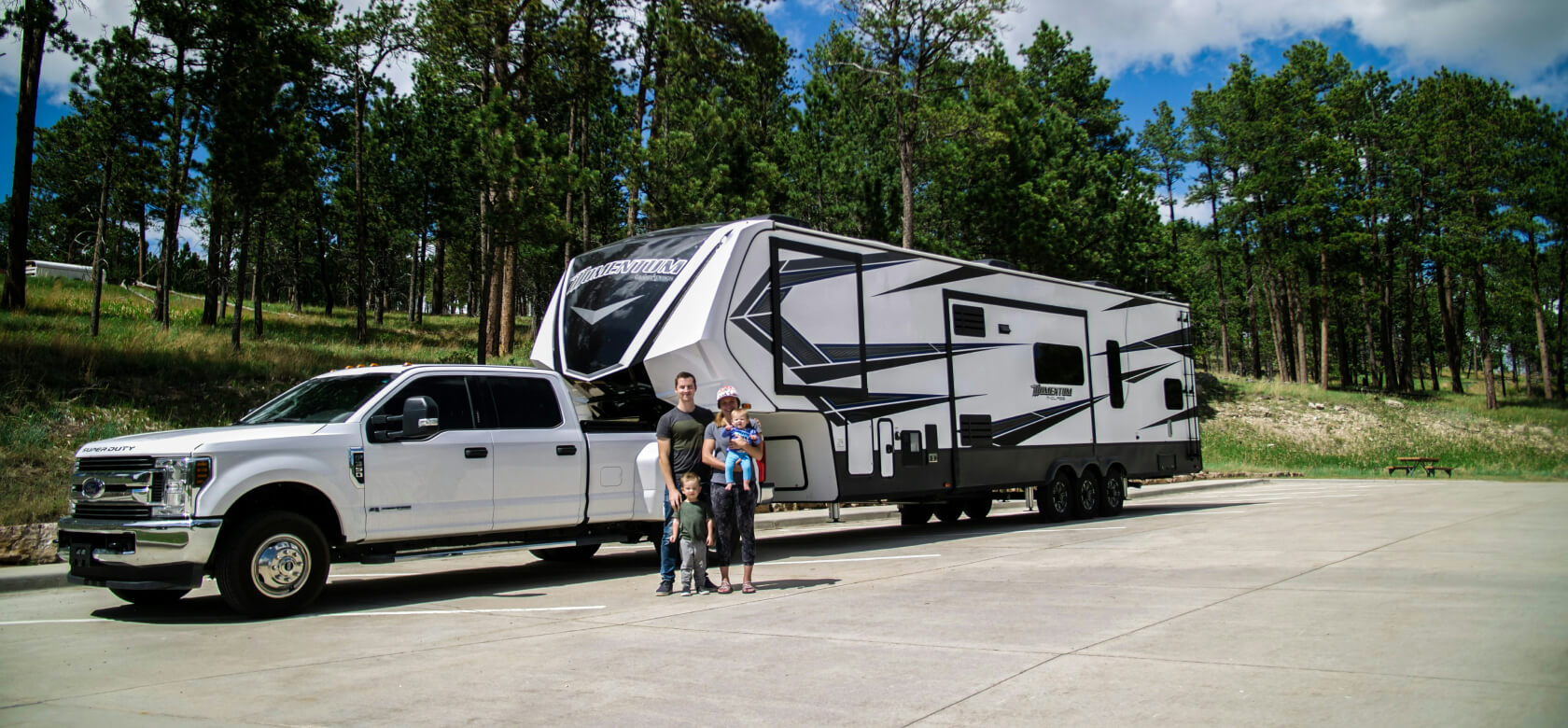 Family with RV and truck at campground