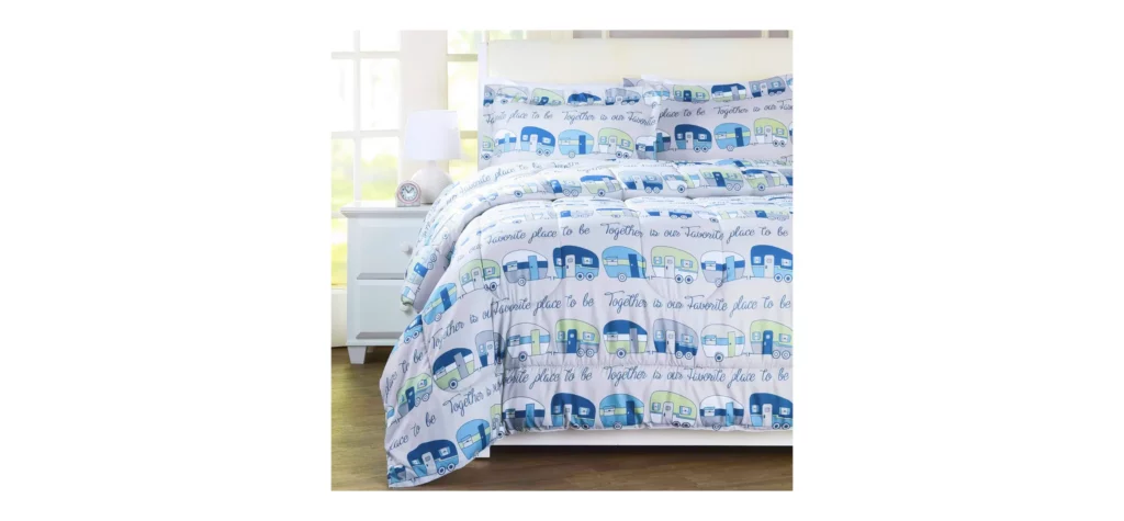 Bed with travel-themed bedding in bright room.